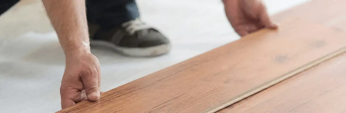 A professional installing laminate flooring in Clearwater, FL